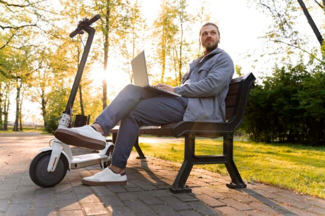man-working-his-laptop-his-scooter electric wheelchairs